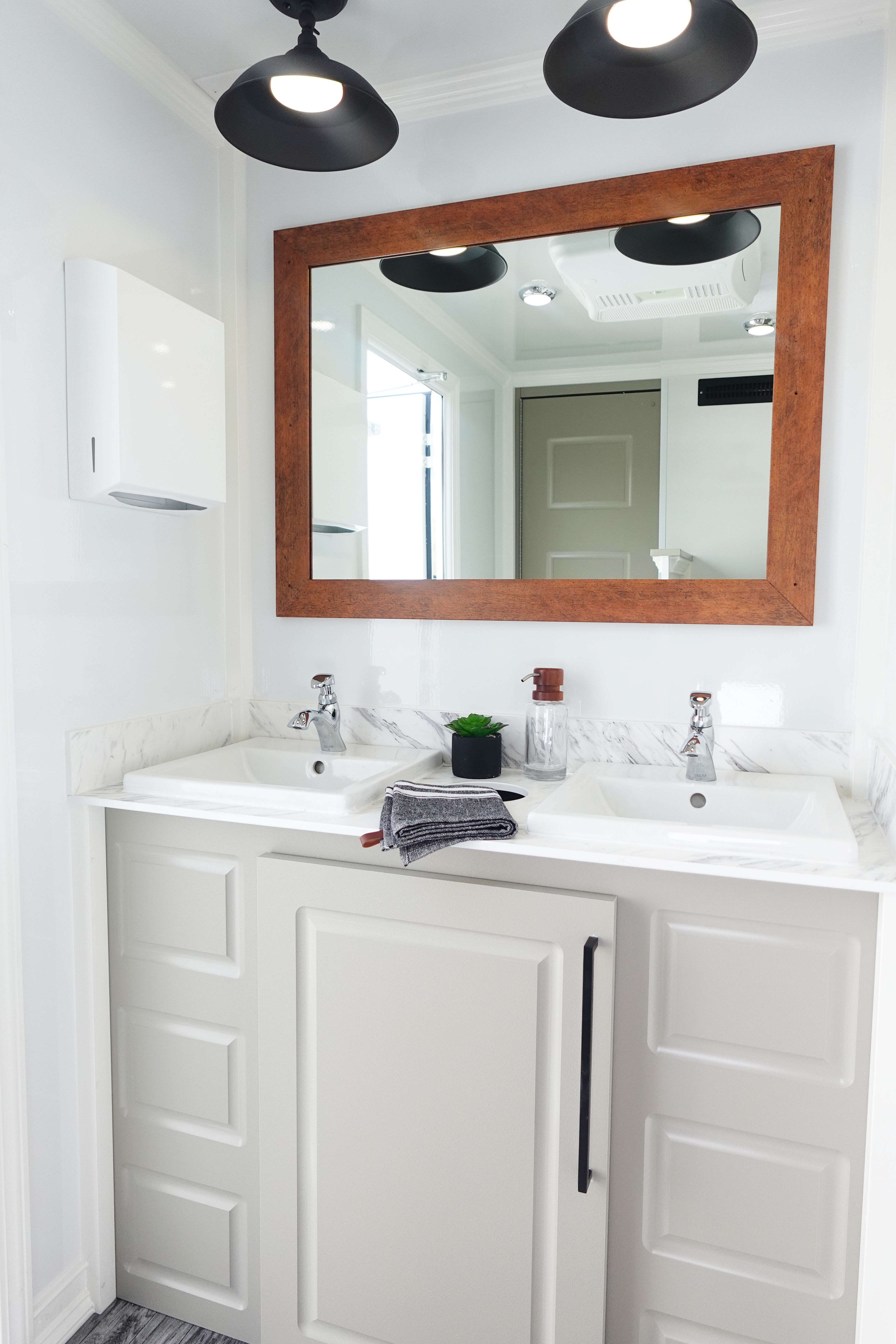 Bright, well-appointed interior vanity inside the Lang Luxury Restroom Retreat