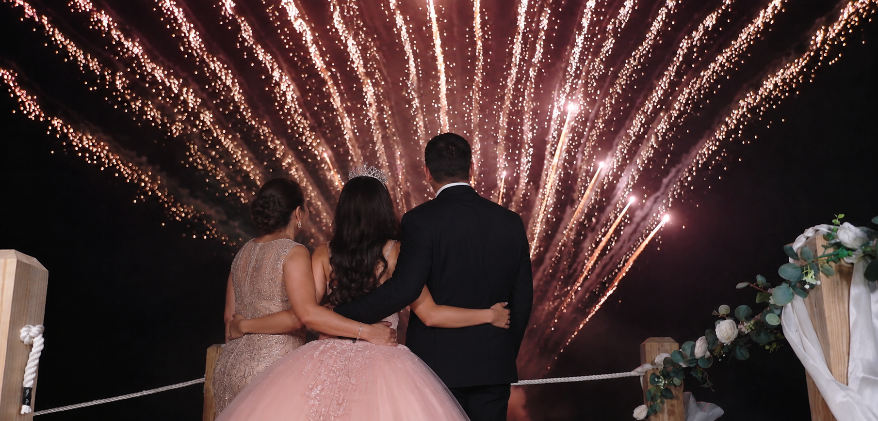 Family watching a beachfront fireworks finale at Seahorse