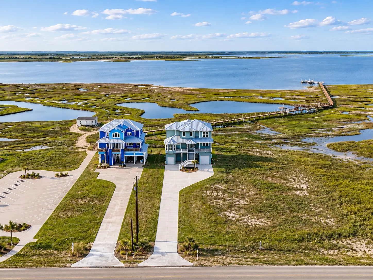 Bay Palace beside protected Drum Bay, with the community boardwalk reaching toward the water.