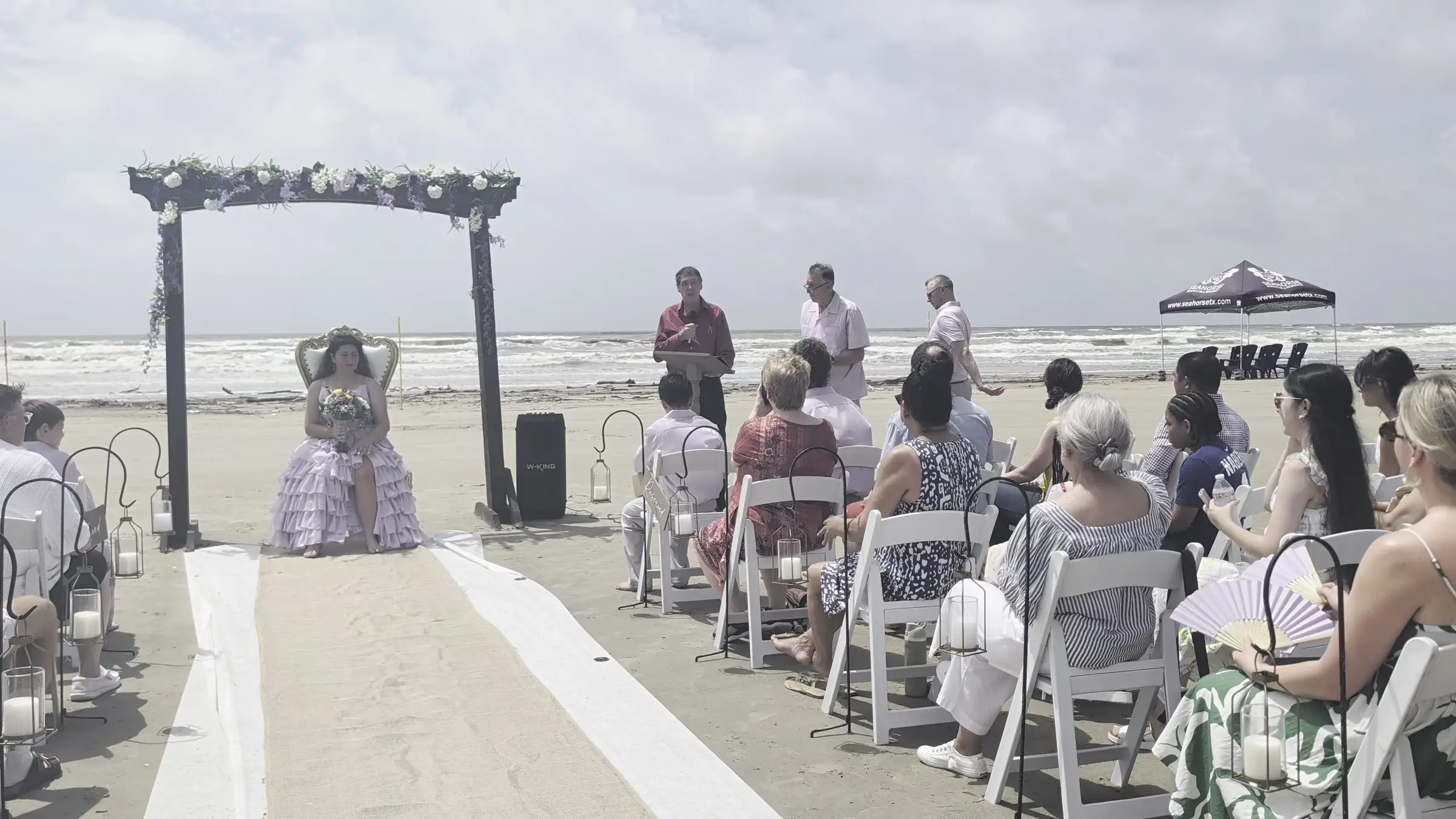 Beachfront quinceañera ceremony with a princess chair beside the Gulf at Seahorse